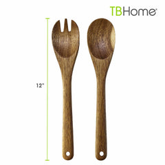 The TB Home® Acacia Wood Salad Serving Set by Totally Bamboo features two 12-inch wooden kitchen utensils: a forked spoon and a regular spoon, each with a hole at the handle's end. They are elegantly displayed on a white background with the "TBHome" logo in the top right corner.