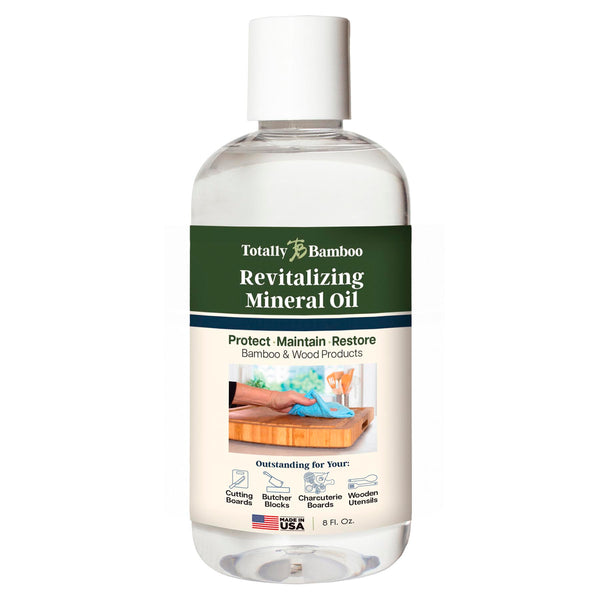 This Totally Bamboo Revitalizing Oil for Cutting Boards, in an 8 fl. oz. bottle and labeled green, protects bamboo and wood items. Featuring a photo of application on kitchen utensils or cutting boards, this USA-made product is ideal for maintaining your kitchen essentials.