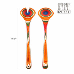 A pair of vibrant wooden utensils adorned with swirling patterns reminiscent of Morocco's lively marketplaces, part of the Totally Bamboo's Baltique® Marrakesh Collection. The set includes one utensil with a slotted design, and both feature a hole at the end of their handles. Each utensil measures 11-3/4 inches in length.