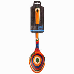 A vibrant birch serving spoon adorned with concentric circles in red, orange, green, and blue. It is packaged in a sleek black box labeled "Baltique® Marrakesh Collection Grand Serving Spoon, 14" by Totally Bamboo.