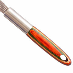 An 11-inch balloon whisk from the Totally Bamboo Baltique® Marrakesh Collection, featuring a metal design and a colorful wooden handle in vibrant shades of red, orange, and green. The handle includes a handy hole for hanging. Positioned artfully on a plain white background, the whisk is displayed diagonally.