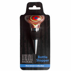 Explore the lively Baltique® Marrakesh Collection Bottle Stopper by Totally Bamboo, drawing inspiration from Morocco's colorful marketplaces. This item features a silver and black rubber stopper topped with a multicolored circular design, presented in sophisticated packaging adorned with a black tree-patterned backdrop.