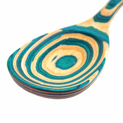 Here's a revised version of the sentence using the product data:

A close-up of the Baltique® Mykonos Collection Cooking Spoon, 12-1/2" by Totally Bamboo, showcases its distinctive swirling pattern in shades of teal and natural wood. The intricate design lends an artistic and textured appearance to the surface, making it a perfect complement to your non-stick cookware.