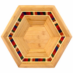 The Baltique® Marrakesh Collection Salad Bowl & Salad Hands Set by Totally Bamboo features a hexagonal wooden design with vibrant, narrow stripe accents in red, blue, green, and orange along the inner rim. Its natural wood grain finish is prominently visible, fusing geometric precision with lively details.