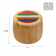 The Marrakesh Collection from Totally Bamboo presents the Baltique® salt cellar, boasting a charming bamboo design with a colorful striped lid. It measures 4 inches in diameter and 3-1/8 inches high and has an 8-ounce capacity. The vibrant red, blue, green, and orange stripes create a striking contrast with the natural wood finish.