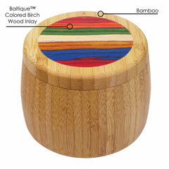 Explore the Totally Bamboo Baltique® Marrakesh Collection, featuring an 8-ounce capacity salt cellar crafted in a round bamboo design. Its lid is beautifully accented with a circular stripe inlay made from vibrant Baltique™ Colored Birch Wood, and text labels highlight its deluxe craftsmanship with the materials "Bamboo" and "Baltique™ Colored Birch Wood Inlay.