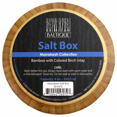 Bamboo circular lid salt cellar featuring a colorful birch inlay, labeled with "Baltique® Marrakesh Collection" by Totally Bamboo. The packaging includes care instructions, 8-ounce capacity information, and you can find a barcode and further manufacturing details on the bottom.