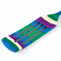 Close-up of a colorful non-stick safe spurtle with a rainbow-like pattern in shades of blue, green, purple, and cream. This vibrant kitchen tool from the Baltique® Mumbai Collection by Totally Bamboo gives the utensil a unique and artistic appearance.