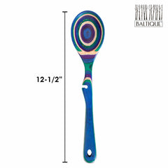 The Baltique® Mumbai Collection Notched Cooking Spoon by Totally Bamboo features a lively design with striped patterns in blue, green, purple, and natural wood tones. Made from colored birch, this spoon is 12-1/2 inches long. The upper right corner is adorned with the Baltique logo alongside tree silhouettes.