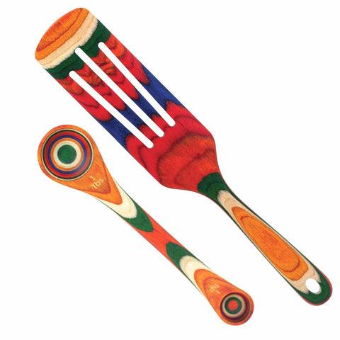 Introducing the Totally Bamboo Baltique® Marrakesh Collection 2-Piece Utensil Set, which includes a colorful spatula and tablespoon crafted from layered wood. This set showcases vibrant patterns with red, green, blue, and natural tones inspired by marketplaces, featuring smooth finishes and eye-catching concentric circle designs.