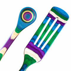 Introducing the dynamic Baltique® Mumbai Collection 2-Piece Utensil Set by Totally Bamboo, featuring a vibrant spatula and spoon with a stunning striped pattern in blue, green, purple, and white. The spoon is designed with measurement markings for precise cooking, while the spatula includes slots for efficient draining. A perfect choice for infusing style into your kitchen!