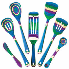 Seven vibrant wooden kitchen utensils from the Totally Bamboo's Baltique® Mumbai Collection 7-Piece Cooking Utensil Set arranged in a semicircle. Each piece, crafted from colored birch, features a distinctive layered rainbow design with shades of blue, green, purple, and yellow. The set includes spatulas, spoons, and a butter knife.