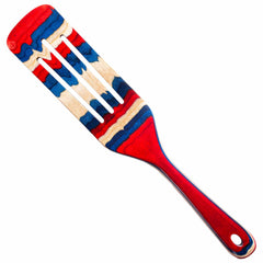 The Baltique® Old Glory Collection Spurtle, 13" from Totally Bamboo is a versatile kitchen tool that showcases a vibrant striped pattern in red, blue, and natural wood tones. Its handle and blade feature alternating colors, resulting in a visually striking design ideal for any culinary task.