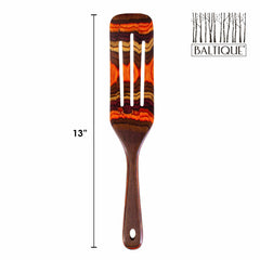 The Baltique® Poconos Collection Spurtle by Totally Bamboo is a 13-inch wooden slotted spatula, showcasing a vibrant layered design in fall-inspired tones of brown and orange. It features the Baltique logo with a tree motif on the top right corner, adding versatility to your kitchen tools.