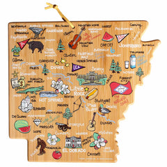 Introducing the Arkansas Cutting Board with Artwork by Fish Kiss™ from Totally Bamboo! This unique cutting board is designed in the shape of Arkansas, featuring a vibrant and whimsical illustration reminiscent of Fish Kiss Artwork. It showcases colorful depictions of towns such as Little Rock, Fayetteville, and Hot Springs, along with various landmarks, musical instruments, animals, plants, and delicious food items like watermelon.