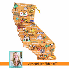 Inspired by the California-shaped cutting boards, this illustrated map of the state against a wooden background emphasizes cities and landmarks. Adorned with small icons such as a bear, trees, and grapes, it includes text reading "Artwork by Fish Kiss™" along with an image captioned "Anne Klein - Owner and Designer". Presented by Totally Bamboo, this is the California Cutting Board with Artwork by Fish Kiss™.