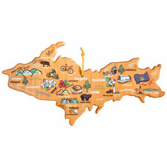 Presenting the Michigan Upper Peninsula Cutting Board with Artwork by Fish Kiss™, crafted by Totally Bamboo. This decorative wooden piece showcases vibrant illustrations of local landmarks, wildlife, and activities, featuring charming depictions of a moose, trees, a bicycle, and town names such as Marquette and Munising.