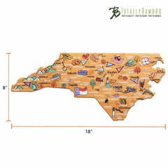 Explore the distinct North Carolina Cutting Board with Artwork by Fish Kiss™, a part of the Totally Bamboo collection. This state-shaped cutting surface boasts vibrant illustrations and labels showcasing local foods, landmarks, and cities such as Raleigh, Charlotte, and Asheville. The board measures 8 inches by 18 inches.