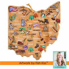 Wooden cutting board featuring an illustrated map of Ohio with labeled cities and colorful icons that celebrate local culture and landmarks, crafted on a bamboo surface. Includes a small photo with the text: "Artwork by Fish Kiss™. Brand: Totally Bamboo.