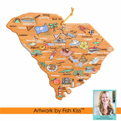 This South Carolina Cutting Board with Artwork by Fish Kiss™ showcases a beautifully illustrated wooden map featuring landmarks and town names. It includes vibrant depictions of local icons such as the palmetto tree, state flag, golf clubs, and beaches. Created by Totally Bamboo, it also features a portrait of artist Anne Klein in the bottom right corner.