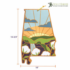 This Alabama-shaped cutting board, featuring artwork by Summer Stokes, beautifully encapsulates the spirit of Alabama with a vivid sunset over mountains and cotton fields. Measuring 15-3/4 by 10 inches, this bamboo cutting surface prominently showcases the "Totally Bamboo" brand at the top.