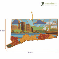 The Connecticut Cutting Board with Artwork by Summer Stokes is a decorative bamboo board shaped like the state of Connecticut. It features detailed engraved illustrations of buildings, a river, mountains, and a ship, crafted in intricate artwork by Summer Stokes. Measuring 9.5 inches by 16.5 inches, this cutting board proudly displays the Totally Bamboo logo in the top corner.