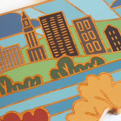 Illustration of a cityscape featuring tall buildings, a clock tower, and lush greenery in the style of Summer Stokes artwork. The vibrant scene is reminiscent of the Connecticut Cutting Board by Totally Bamboo, showcasing stylized trees in the foreground against a colorful background.