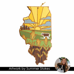 Experience the charm of Illinois with the Illinois Cutting Board, featuring artwork by Summer Stokes. This stunning piece from Totally Bamboo showcases a yellow sunrise, silos, a cow, and cornfields in an illustrated style. An artist with a dog is depicted in the corner, alongside the text “Artwork by Summer Stokes,” inspired by the farm life allure of state-shaped cutting boards.