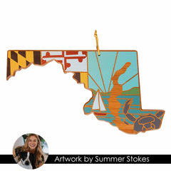 Totally Bamboo's Maryland Cutting Board showcases a unique design by Summer Stokes, featuring a wooden ornament shaped like the state of Maryland. This piece includes stylized elements such as a crab, sailboat, sun, and the Maryland flag motif. It also features a circular portrait of a smiling woman with her dog labeled "Summer Stokes Artwork," making it an ideal addition for collectors of state-shaped cutting boards.