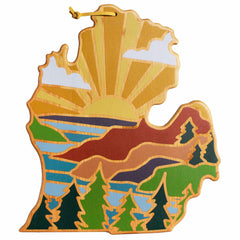 The Michigan Mitten Cutting Board, crafted by Totally Bamboo and featuring the artwork of Summer Stokes, beautifully represents Michigan's Lower Peninsula. It showcases a vibrant landscape with sunrise, hills, trees, and water in bright hues of yellow, green, brown, and blue. Designed for convenience, it includes a loop for easy hanging.