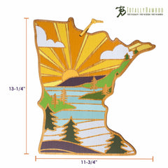 The Minnesota Cutting Board with Artwork by Summer Stokes from Totally Bamboo displays a colorful depiction of Minnesota's landscape, complete with a sunset, trees, and a river. It measures 13-1/4 inches in height and 11-3/4 inches in width, providing a unique and stylish bamboo cutting surface for any kitchen.