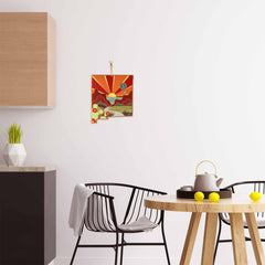 In a modern kitchen, a wooden table is set for tea with a white teapot and three lemons, complemented by elegant black chairs. The wall is adorned with artwork from Summer Stokes featured on the New Mexico Cutting Board by Totally Bamboo. A small green plant adds a touch of freshness to the countertop next to this bamboo cutting surface.