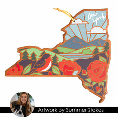 The New York Cutting Board with Artwork by Summer Stokes from Totally Bamboo is a stylish wooden piece shaped like the state of New York, featuring a scenic illustration of a robin, roses, mountains, trees, and a sunrise. It serves as both an attractive ornament and a functional bamboo cutting surface. The word "New York" is elegantly displayed in the top right corner.