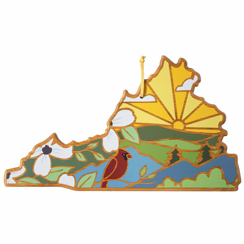 This Virginia Cutting Board with Artwork by Summer Stokes from Totally Bamboo features a vibrant design depicting a sunrise over rolling hills adorned with white flowers and a red bird set against a picturesque green and blue landscape, mirroring the beauty of state-shaped cutting boards.