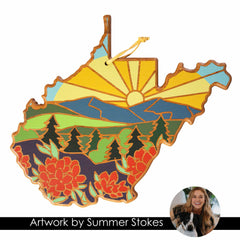 This exquisite wooden ornament, the West Virginia Cutting Board with Artwork by Summer Stokes from Totally Bamboo, is shaped like West Virginia and features a vibrant nature scene with a sunrise over mountains, trees, and red flowers. A circular photo of an unidentified person with a dog graces the lower-right corner.