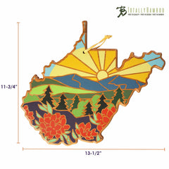 The West Virginia Cutting Board by Totally Bamboo features a vibrant artwork by Summer Stokes, showcasing a sunrise over mountains and trees in the state, accented with red flowers. Crafted from bamboo, it measures 11-3/4 inches tall and 13-1/2 inches wide, making it both a functional and decorative piece.