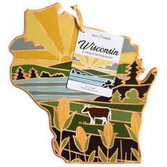 This Wisconsin Cutting Board with Artwork by Summer Stokes from Totally Bamboo showcases a sunrise over fields with a cow and trees. Made from bamboo, it comes with a tag that provides product information for your convenience.